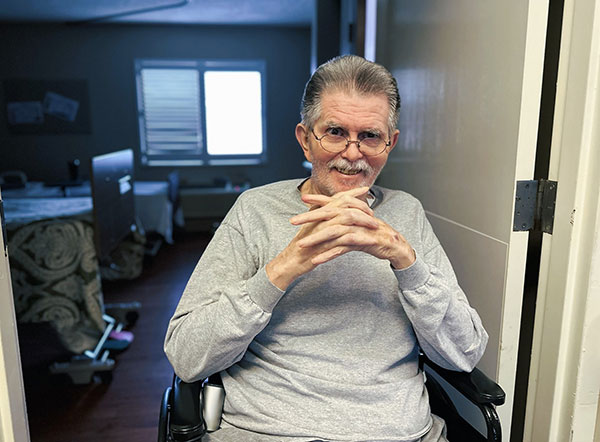 Senior man smiling in hospital room
