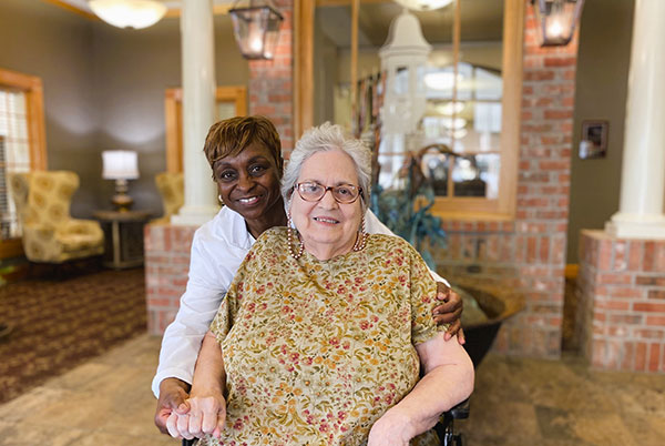 Nurse and patient smiling in lobby